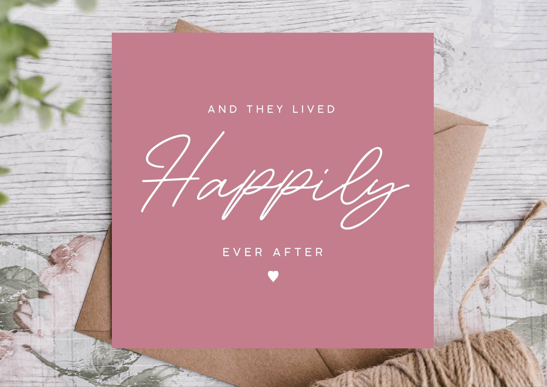 Pink card with 'And They Lived Happily Ever After' text with a kraft envelope behind it.