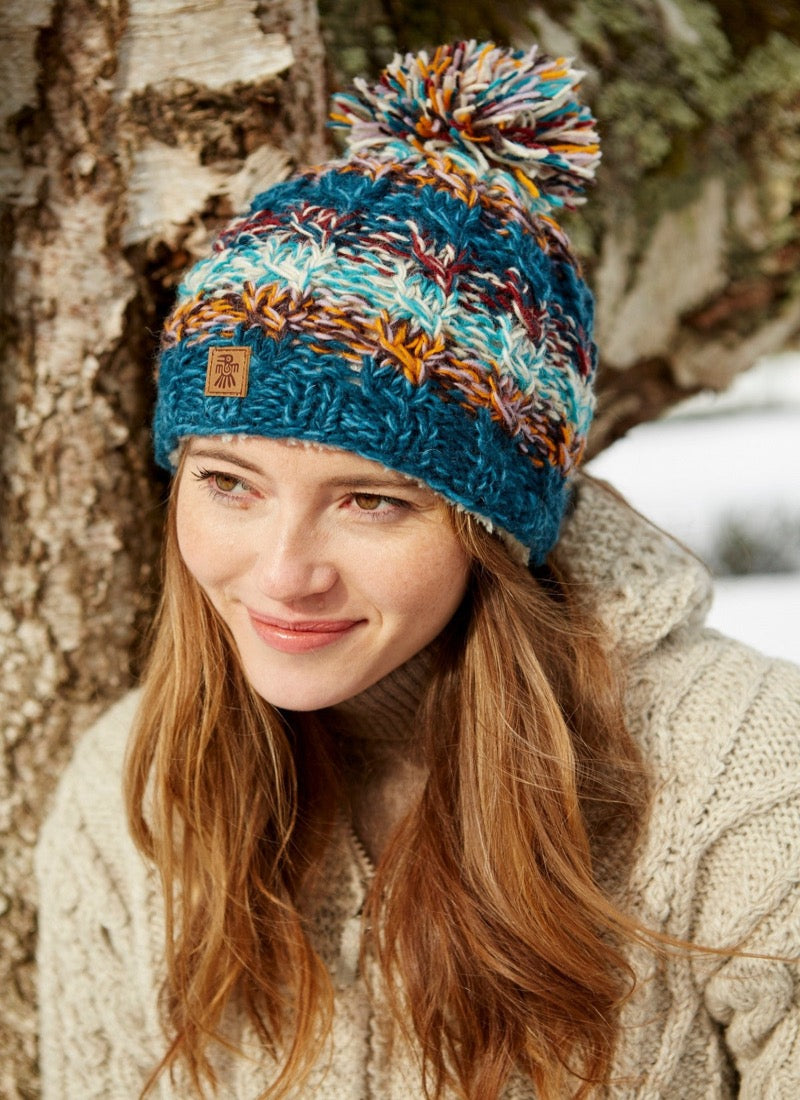 Utrecht bobble beanie in a blue brown, red & white mix.
