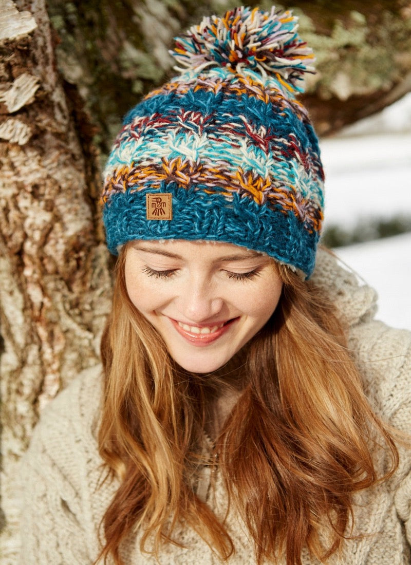 Utrecht bobble beanie in a blue brown, red & white mix.