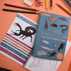 Two educational books on a table with pencils and an eraser.