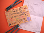 Coloring book titled 'Amazing British Coastline' with pencils and coloring pages on an orange background