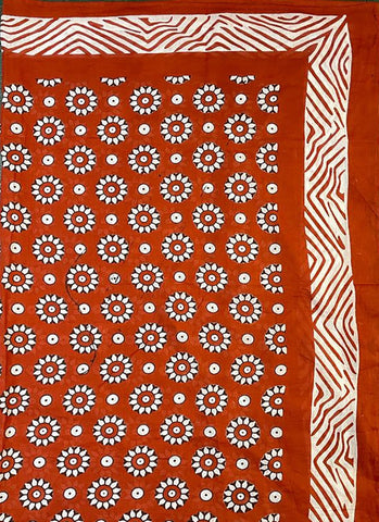 Coggs rust cotton scarf / sarong handprinted with an all over floral pattern.