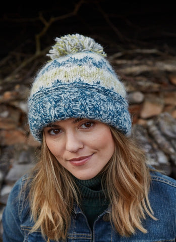 Totnes bobble beanie in a green and blue mix, with a bobble on the top