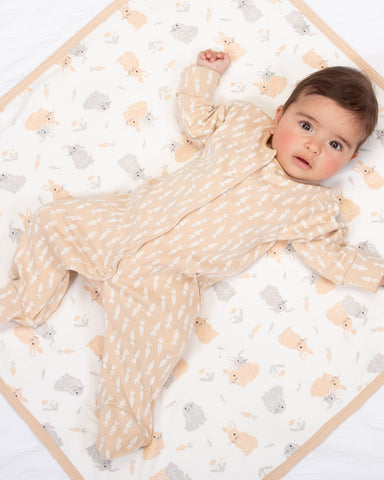 Sleepsuit in soft orange with carrot design printed all over.