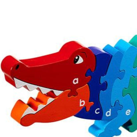 a crocodile shaped wooden jigsaw with the alphabet printed on. 
