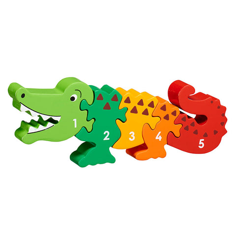 Wooden jigsaw in the shape of a crocodile in rainbow colours with 1-5 printed on the pieces